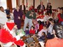 Santa entertains a happy crowd.